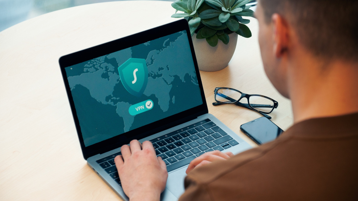 Man Using Laptop Computer with VPN Icon on Screen