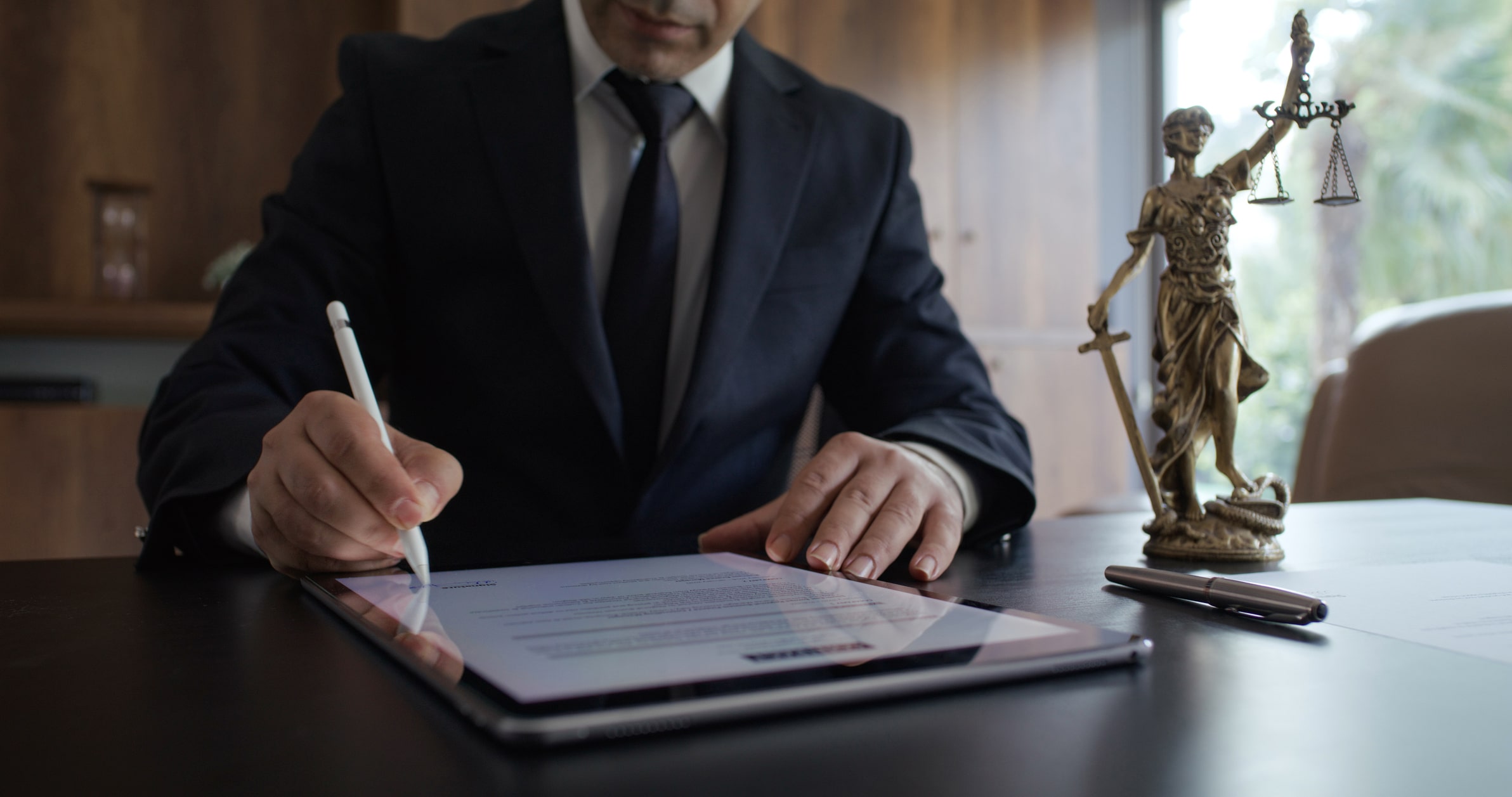 Lawyer signing digital document using digital tablet and digitized pen