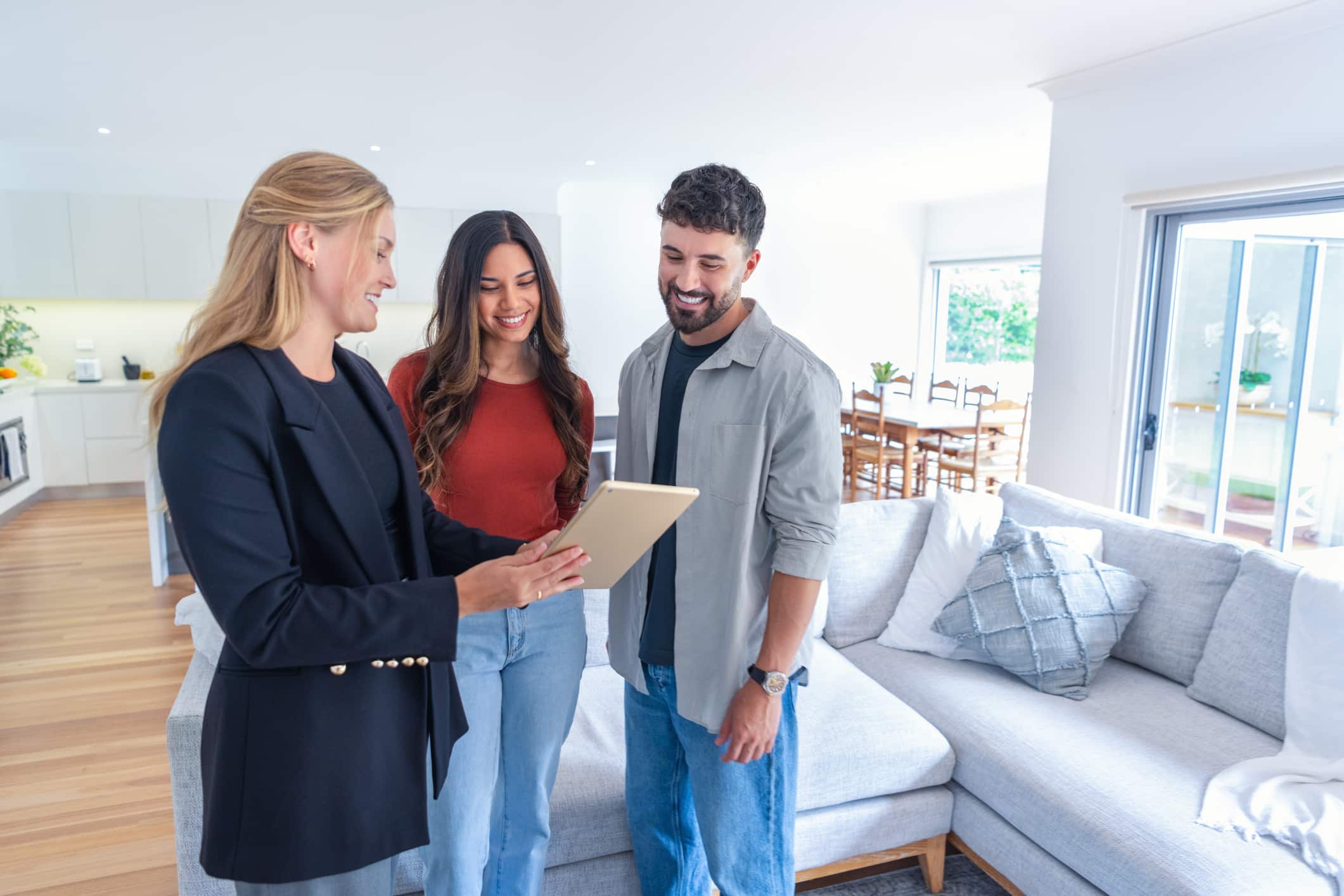 Real estate agent or architect showing a couple a new home